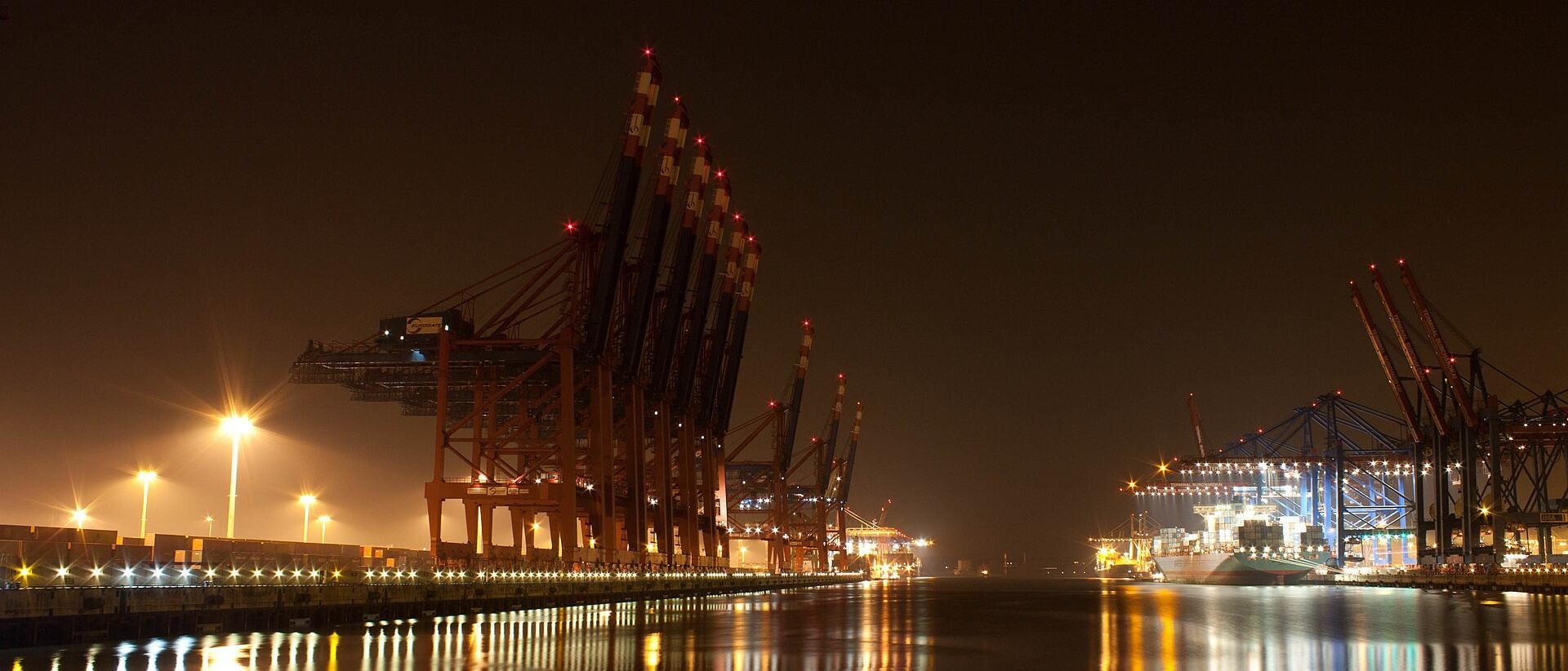 Container cranes at a port at night